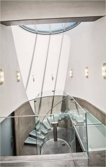 Trapper laget av glass og betong i en halvsirkelformet hus