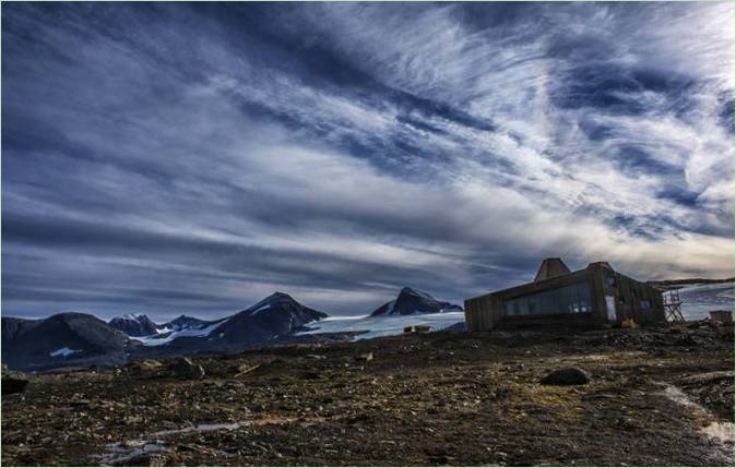 Rabothytta cottages in the mountains: hus under en skyet himmel